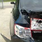 Before and after photographs of a damaged black Volkswagon Jetta that was repaired by Elite Paint & Body Shop in West Palm Beach, Florida.